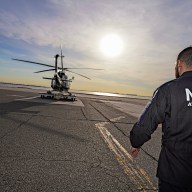 Police officer approaching an NYPD helicopter