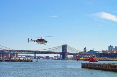 Helicopter flying over East River in NYC
