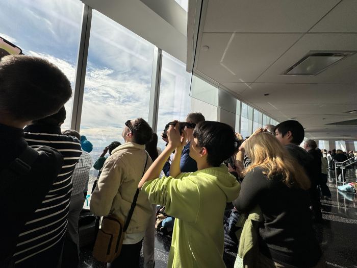 A group gathers to watch the solar eclipse at One World Observatory.