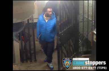 photo of a suspect wearing a blue winter jacket in a West Village subway station, wanted for robbery and assault