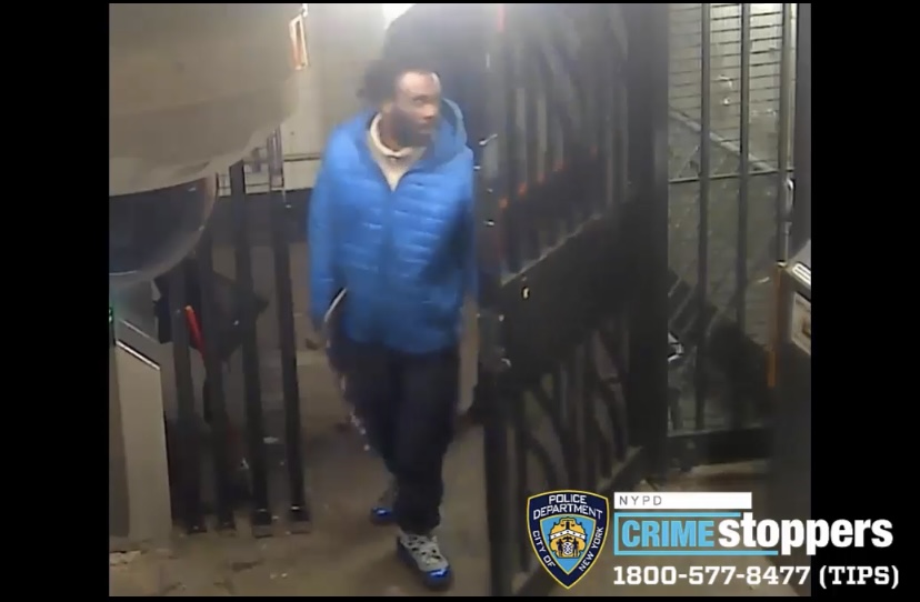 photo of a suspect wearing a blue winter jacket in a West Village subway station, wanted for robbery and assault