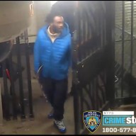 photo of a suspect wearing a blue winter jacket in a West Village subway station, wanted for robbery and assault