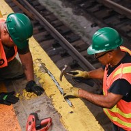 MTA workers repairing cracked subway station platform during 'Re-NEW-vation' repair program
