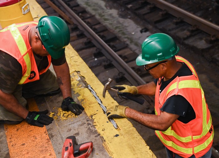 MTA workers repairing cracked subway station platform during 'Re-NEW-vation' repair program