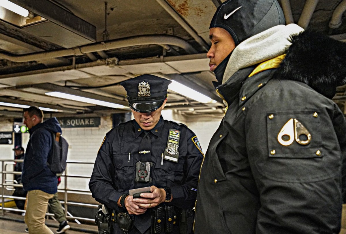police officer stops an individual for alleged fare evasion