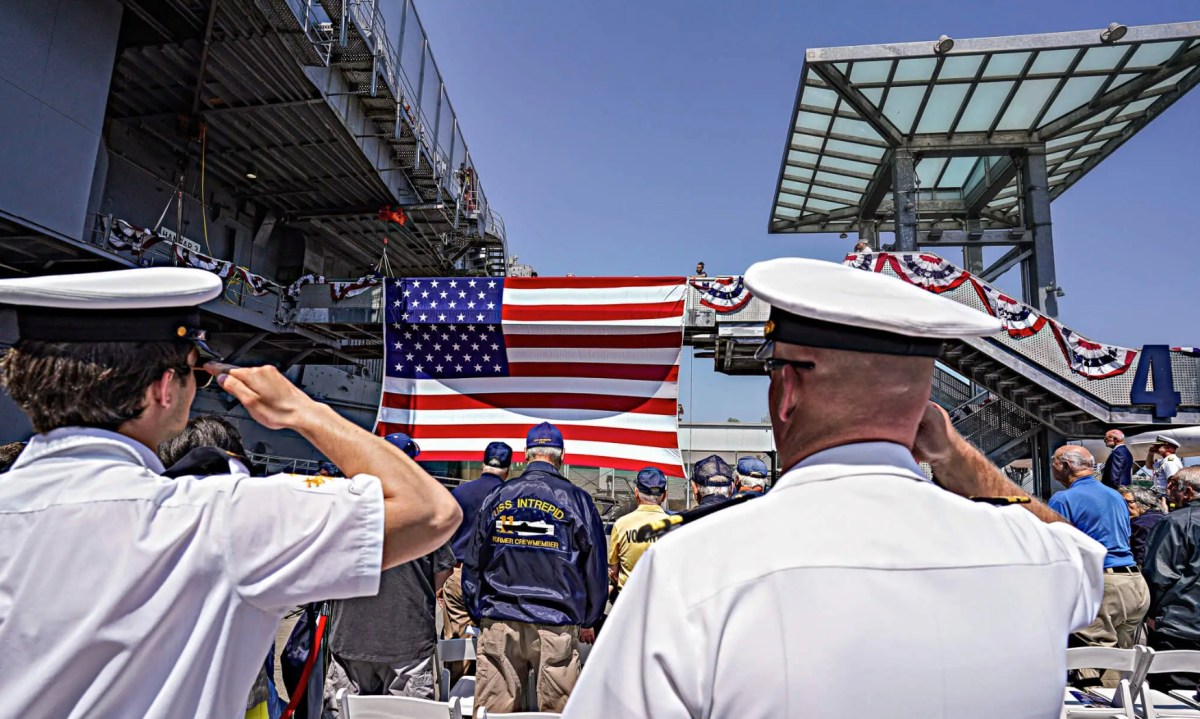 Navy officers salute during Memorial Day service amid Fleet Week