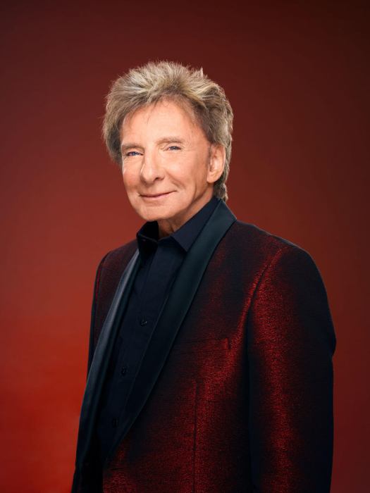 singer Barry Manilow wearing a red jacket