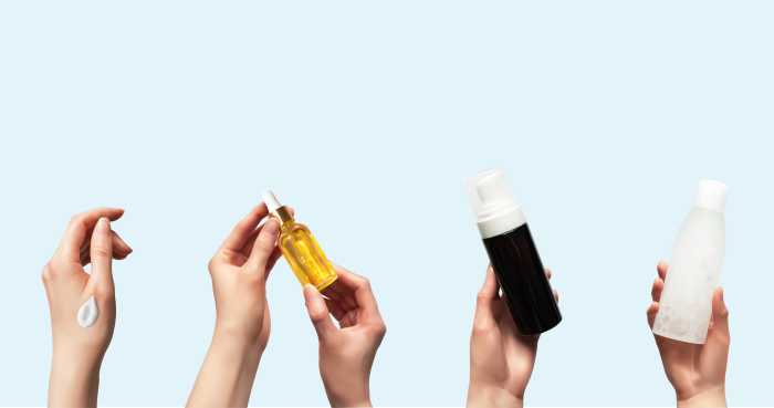 Hands up holding beauty cosmetic products isolated on blue background horizontal banner format 3d realistic vector illustration. Woman takes oil serum, toner bottle, foam cleanser, smear cream