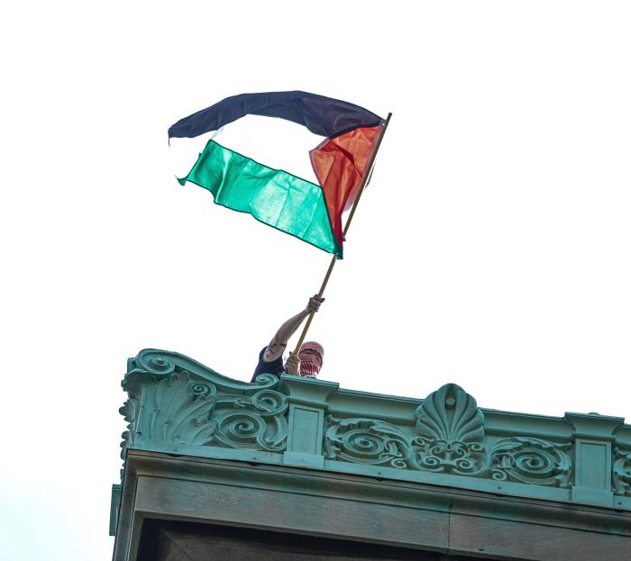 Columbia University protester waves Palestinian flag from rooftop