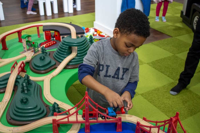 child playing with a toy track at Play Street Museum, a children's museum in NYC
