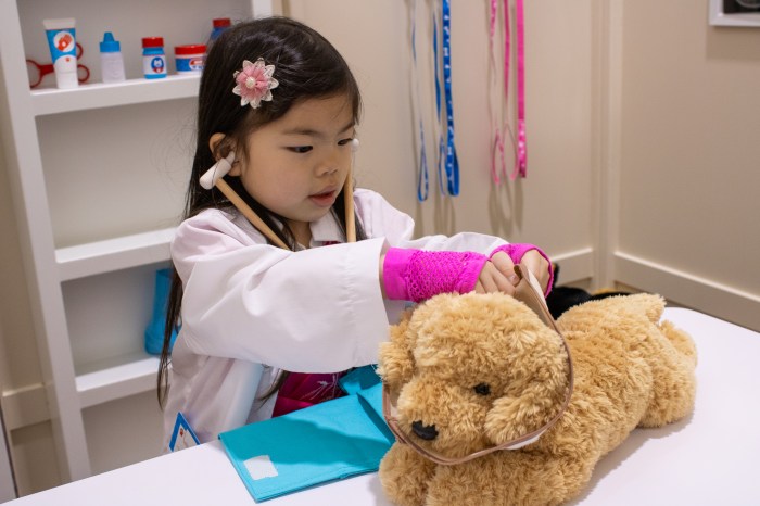 child playing with plush dog at Play Street Museum, a children's museum in NYC