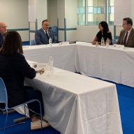 several people at a table, including Miguel Cardona, discussing student loan forgiveness