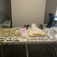 Fentanyl, cocaine and cash that was seized from a Bronx apartment displayed on a table