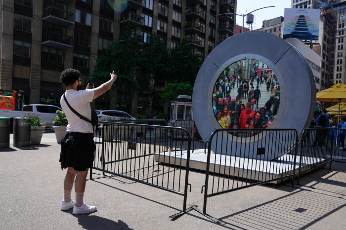 Man taking photo of The Portal in New York