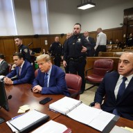 Donald Trump seated with lawyers in courtroom during trial