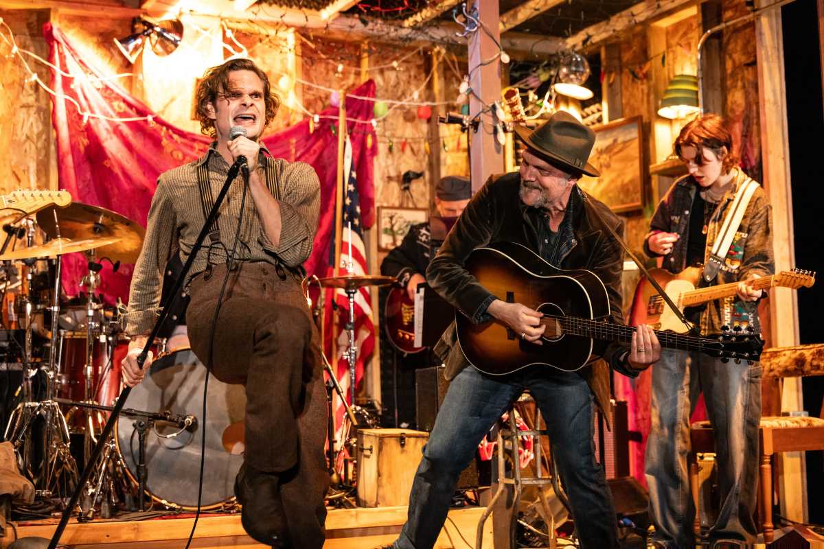 Dead Outlaw cast members singing