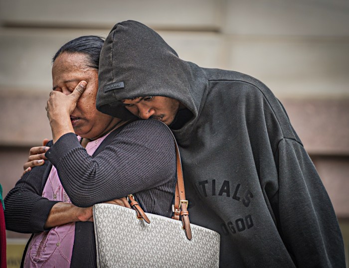 Family members of Win Rozario grieve at rally following police shooting