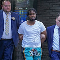 Suspect in Midtown recording studio shooting escorted by detectives in handcuffs