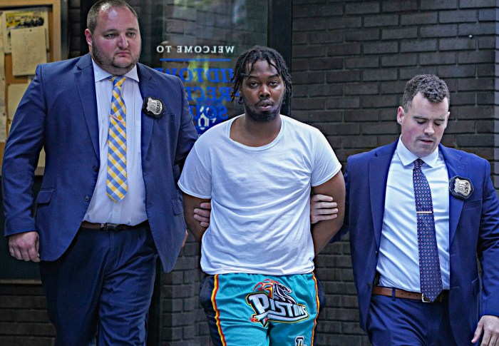 Suspect in Midtown recording studio shooting escorted by detectives in handcuffs