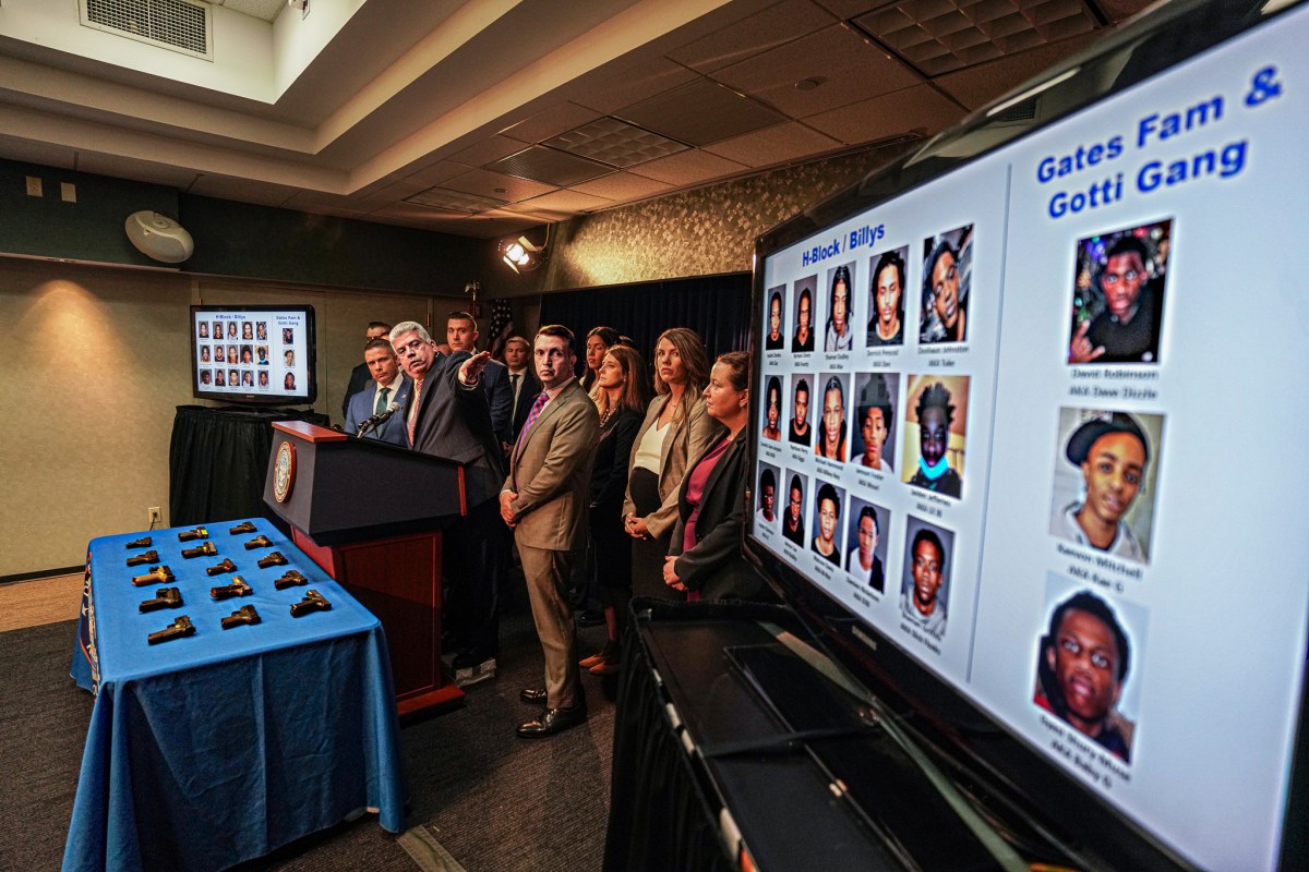 Brooklyn prosecutors and police stand before chart of street gang members
