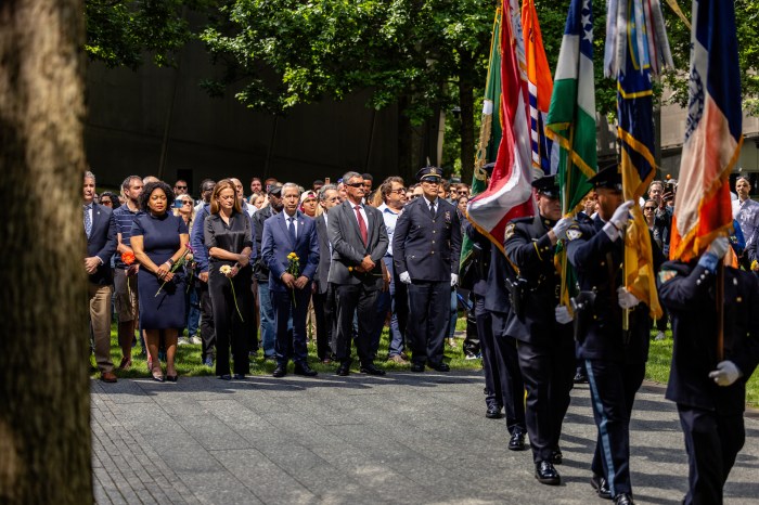 World Trade Center health program could face service cuts by 2028 3 people attending a ceremony outside at the 9/11 Memorial