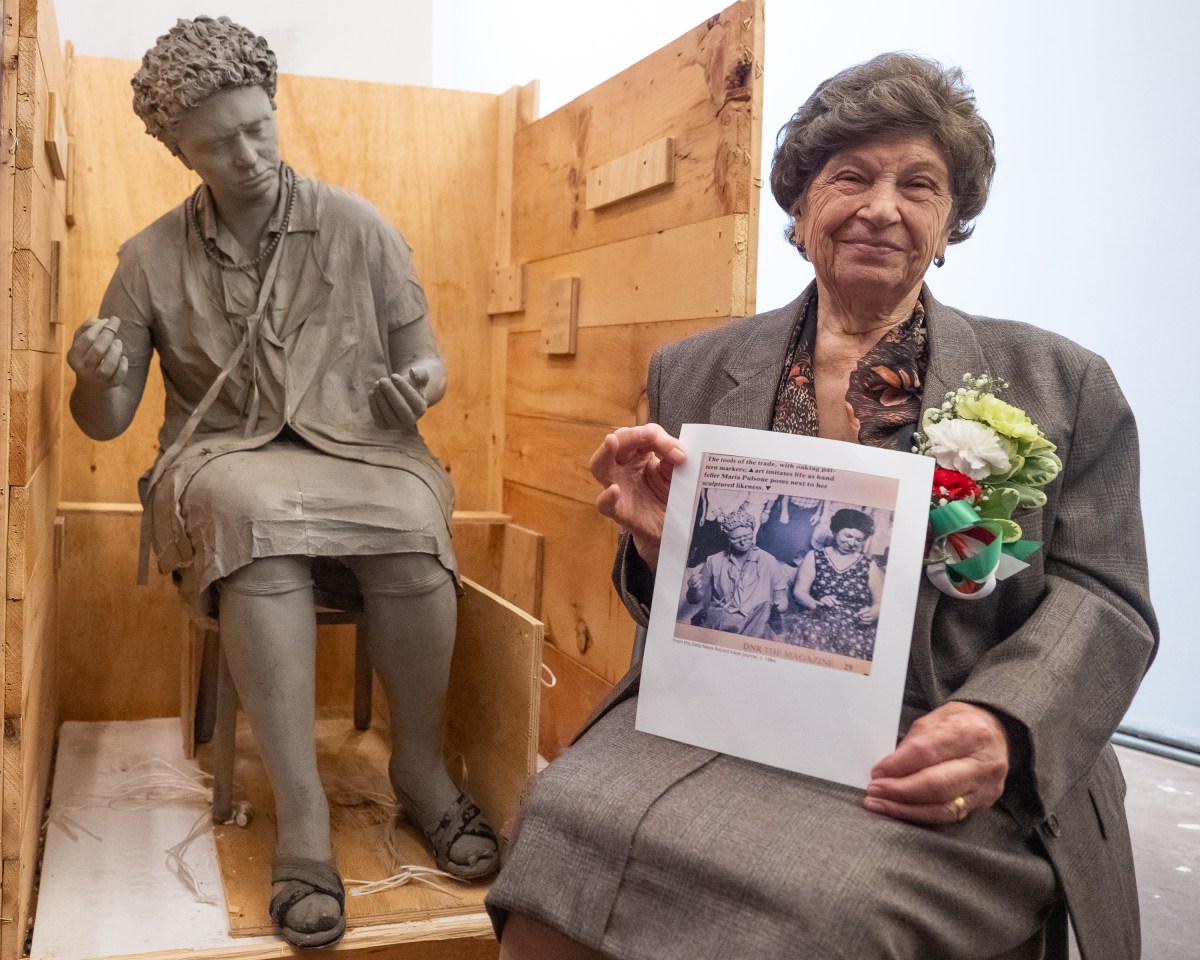 Retired seamstress Maria Pulsone next to her long lost statue which will be on display at the Italian American Museum in Little Italy.