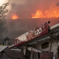 Flames shoot through the roof of a Brooklyn supermarket during a five-alarm fire on May 1, 2024.