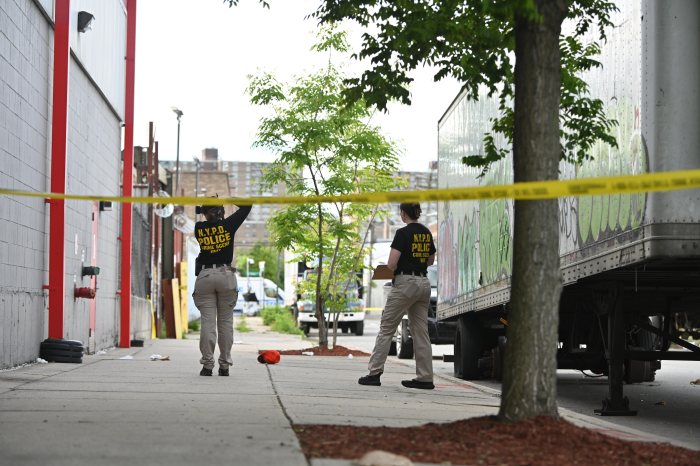 Crime scene unit members in Brooklyn check shooting scene