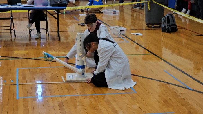 two students working on a project in a Brooklyn school gym
