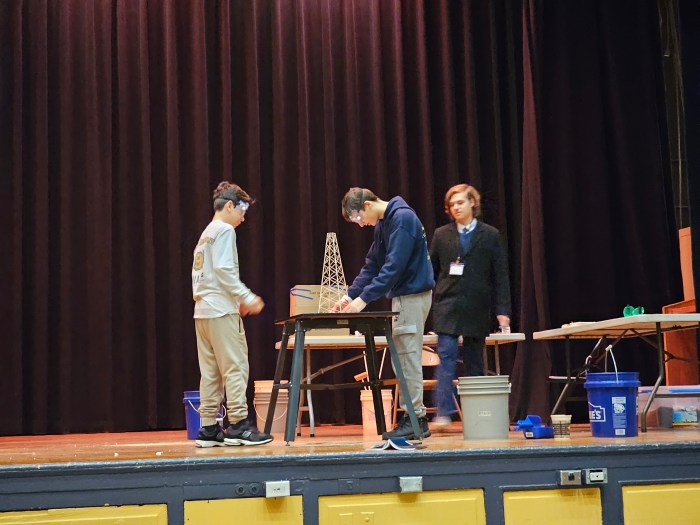 students on stage making a science experiment
