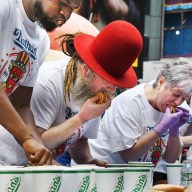 Contestant eating hot dog in Nathan's Hot Dog Eating Contest qualifier in Times Square