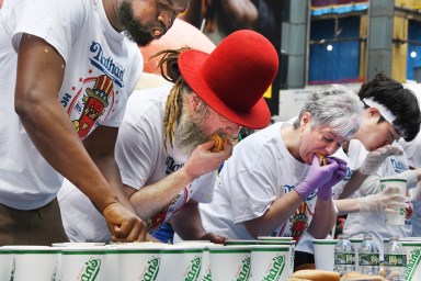 Contestant eating hot dog in Nathan's Hot Dog Eating Contest qualifier in Times Square