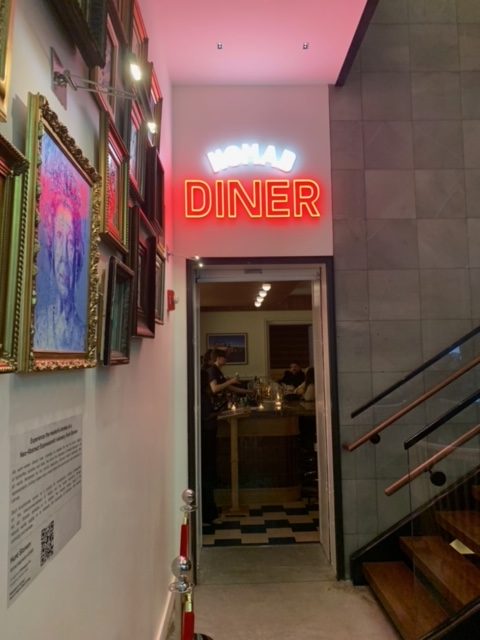 sign above a door that reads NoMad Diner