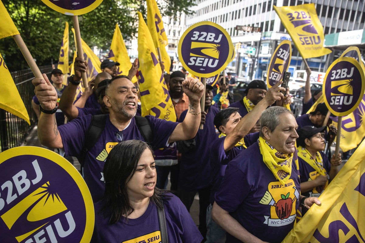 a group of NYC public school cleaners and handypresons holding signs that read 32BJ SEIU