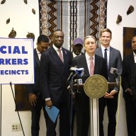 men in suits at a podium discussing social workers at NYPD police stations in NYC
