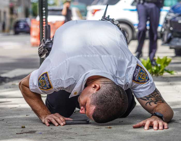 A police officer investigates a shooting scene