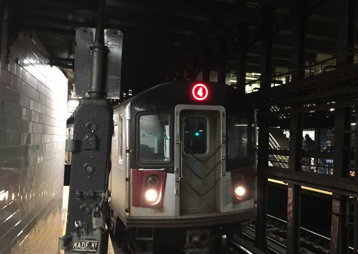 A 4 train enters a station in Manhattan