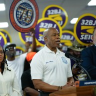 Mayor Adams announces community hiring initiative in front of 32BJ union members holding signs
