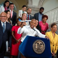 Mayor Eric Adams holds plane during NYC budget deal announcement