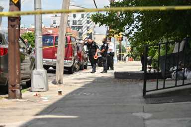Police investigate a shooting at Pitkin Avenue and Ashford Street.