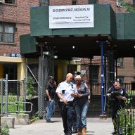 Police in Brooklyn escort resident from scene where teen was shot