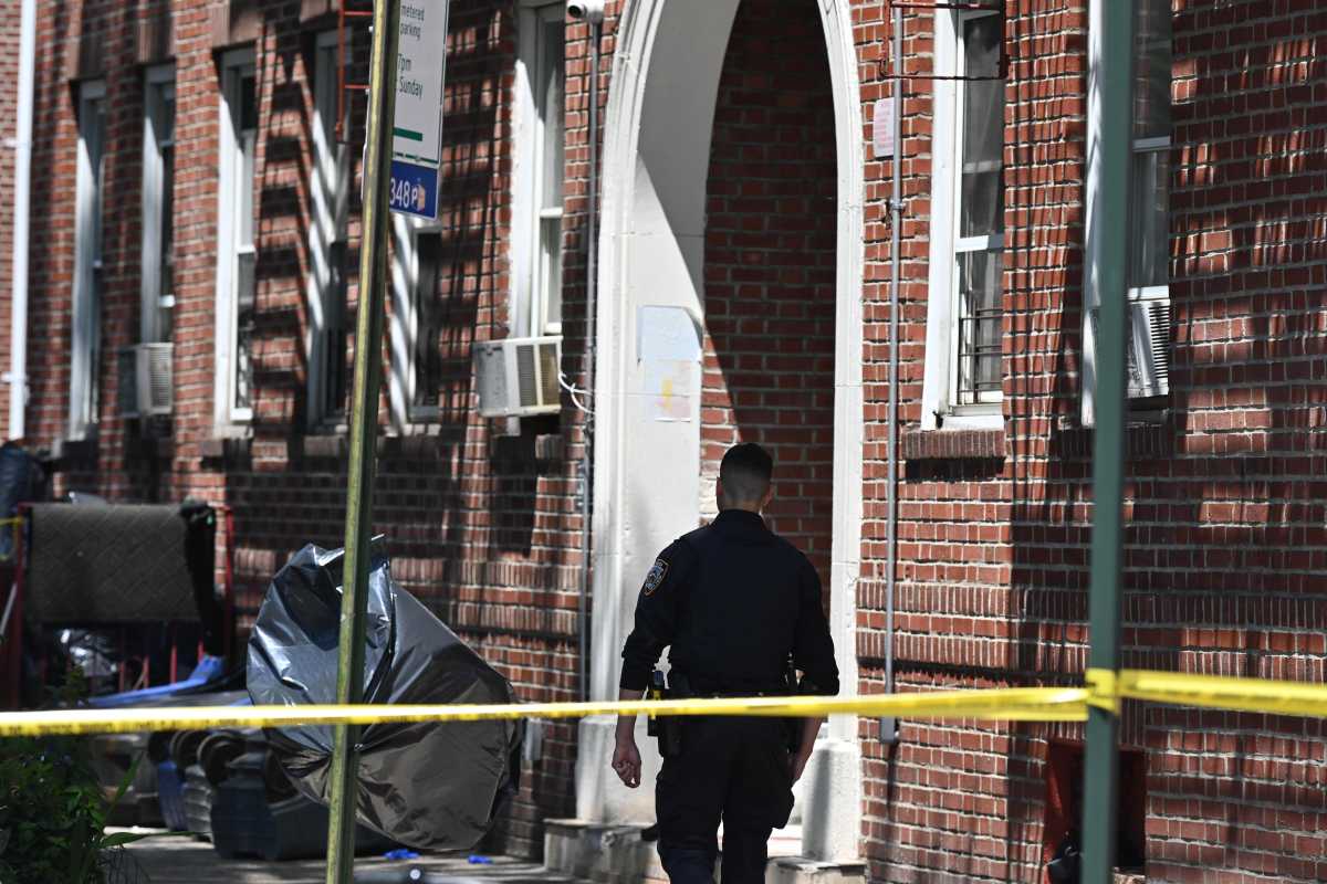 brooklyn police officer guards crime scene after man was shot