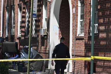 brooklyn police officer guards crime scene after man was shot