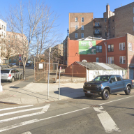 intersection in the bronx showing apartment buildings and cars