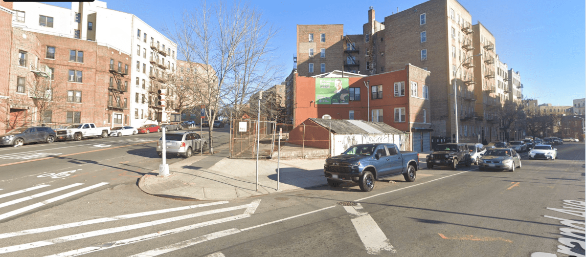 intersection in the bronx showing apartment buildings and cars