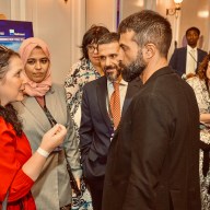 man in black jacket, Mosab Hassan Yousef , speaks with a woman wearing red