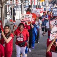 nurses wearing red picketing outside New York Eye and Ear