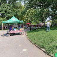 park in Brooklyn with a table and tent set up