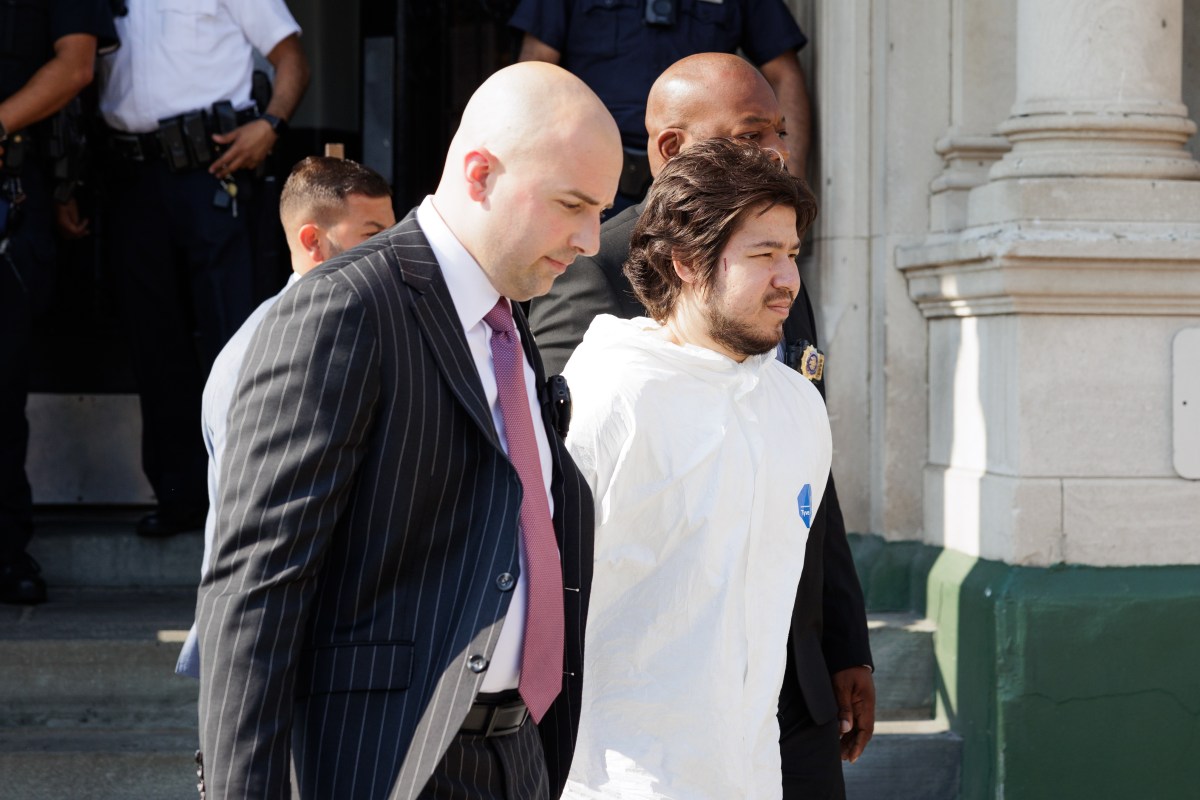 Officers from the 62nd Precinct walk Shahdoz Rajabboev, 24, out of the precinct in Bath Beach