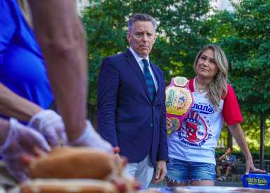 Host George Shea (left) and women’s champion Miki Sudo.